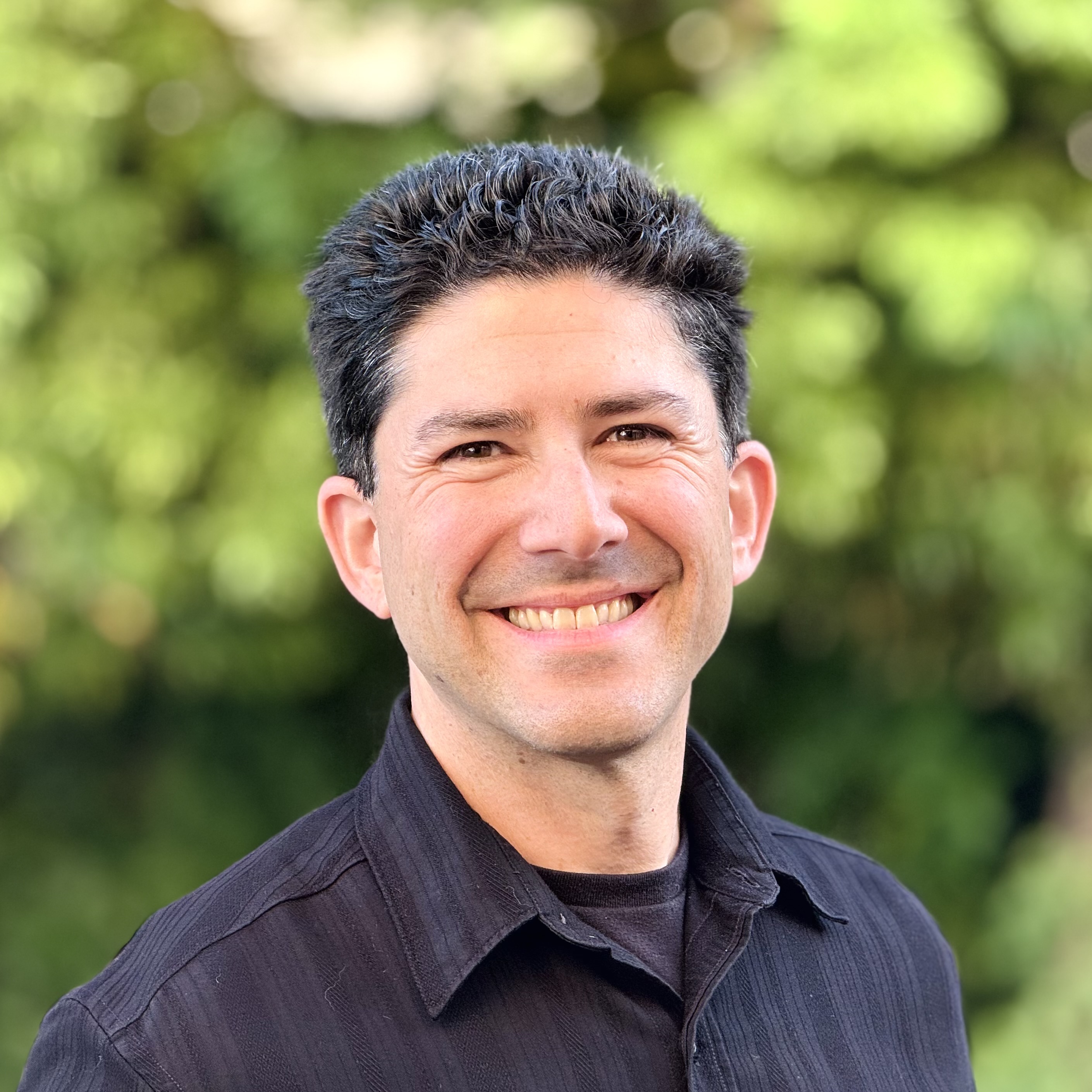 Tony Casparro, author of Puddle and Munch: The Time Stone, smiling outdoors.